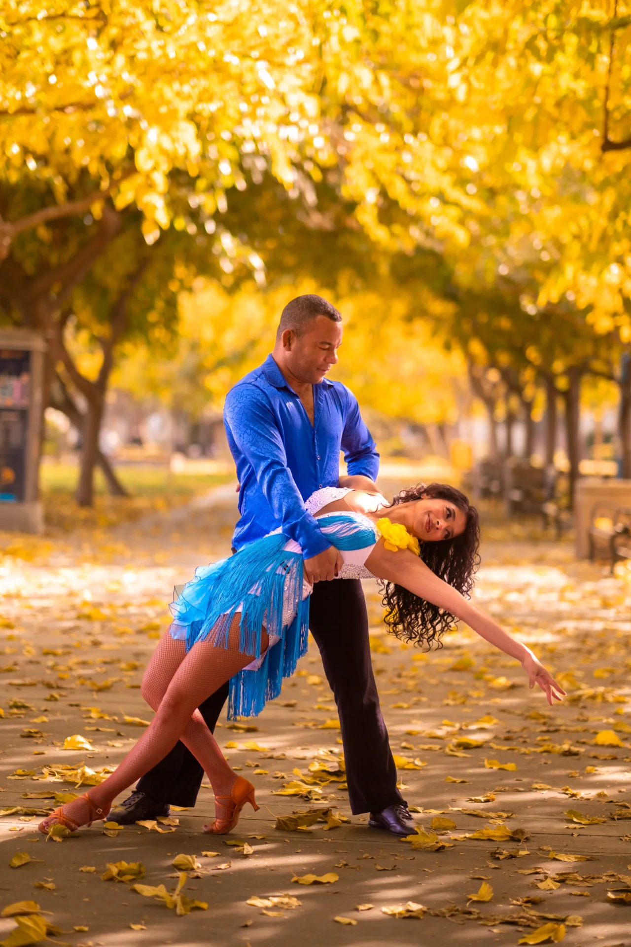 Takeshi Young and Dipanwita Ray dancing beneath golden autumn trees